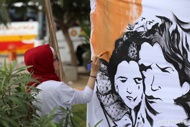 A Palestinian artist paint on a mural during a protest against the 100th anniversary of Britain's Balfour Declaration in Gaza City on November 2, 2017, which helped lead to Israel's creation and the Israeli-Palestinian c...