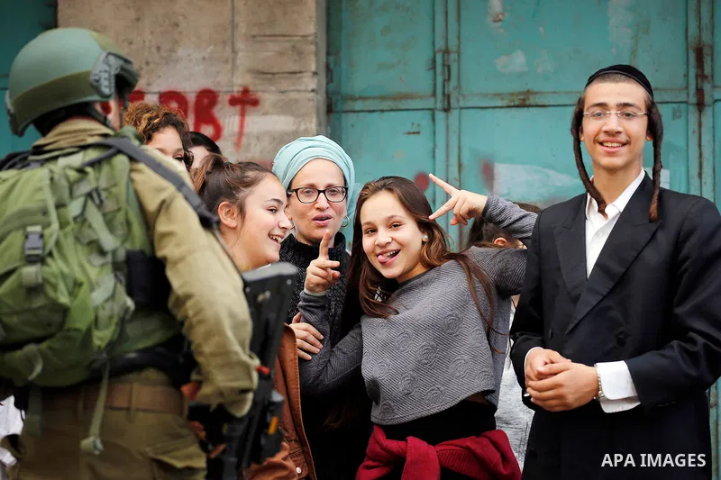 Israeli settlers walk towards the tomb of Atnaeil Ben Kinaz, a Jewish religious site during an annual pilgrimage organised by Israel's settler movement on the occasion of the Chayei Sarah (Life of Sarah) commemorations i...