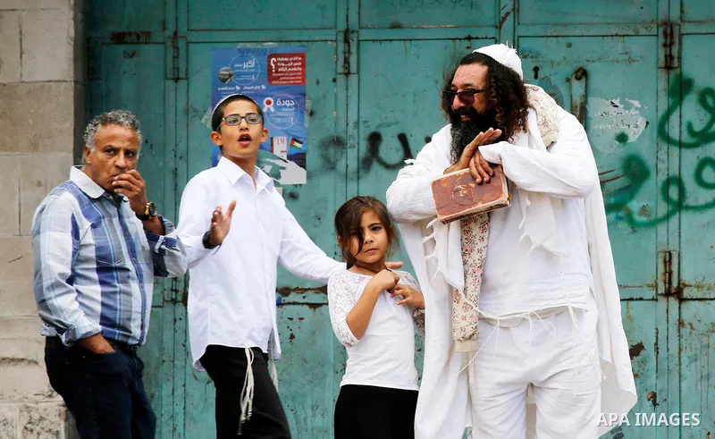 Israeli settlers walk towards the tomb of Atnaeil Ben Kinaz, a Jewish religious site during an annual pilgrimage organised by Israel's settler movement on the occasion of the Chayei Sarah (Life of Sarah) commemorations i...