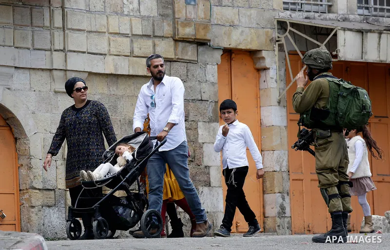 Israeli settlers walk towards the tomb of Atnaeil Ben Kinaz, a Jewish religious site during an annual pilgrimage organised by Israel's settler movement on the occasion of the Chayei Sarah (Life of Sarah) commemorations i...