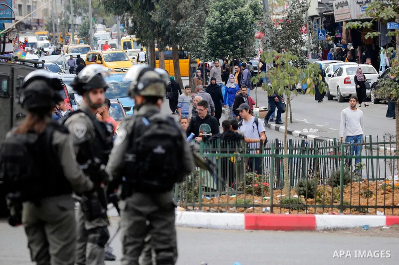 Israeli soldiers stand guard as Israeli settlers walk towards the tomb of Atnaeil Ben Kinaz, a Jewish religious site during an annual pilgrimage organised by Israel's settler movement on the occasion of the Chayei Sarah...