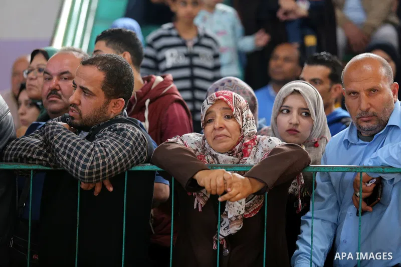 Palestinians wait for travel permits to cross into Egypt under the control of the Palestinian Authority, in Khan Younis in the southern Gaza Strip November 18, 2017, as it opened for three days for the first time since t...