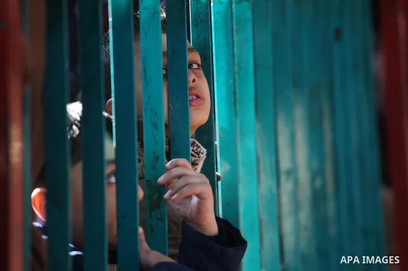 Palestinians wait for travel permits to cross into Egypt, after Rafah border crossing was opened under control of the Western-backed Palestinian Authority for the first time since 2007, in Khan Younis in the southern Gaz...