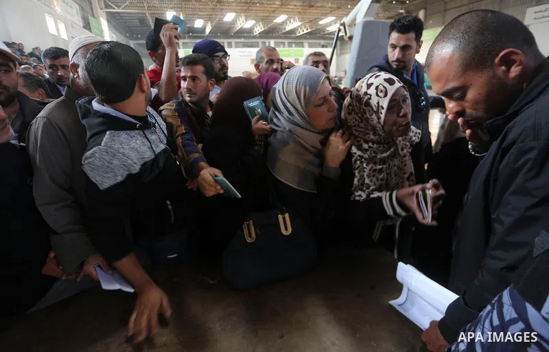 Palestinians wait for travel permits to cross into Egypt, after Rafah border crossing was opened under control of the Western-backed Palestinian Authority for the first time since 2007, in Khan Younis in the southern Gaz...
