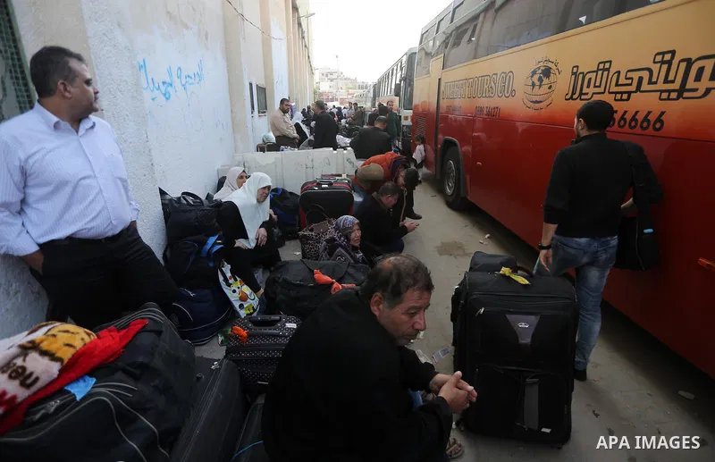 Palestinians wait for travel permits to cross into Egypt, after Rafah border crossing was opened under control of the Western-backed Palestinian Authority for the first time since 2007, in Khan Younis in the southern Gaz...