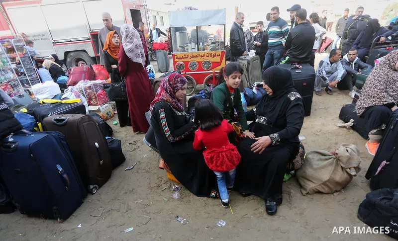 Palestinians wait for travel permits to cross into Egypt, after Rafah border crossing was opened under control of the Western-backed Palestinian Authority for the first time since 2007, in Khan Younis in the southern Gaz...