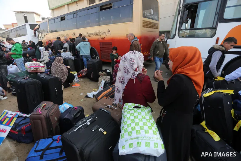 Palestinians wait for travel permits to cross into Egypt, after Rafah border crossing was opened under control of the Western-backed Palestinian Authority for the first time since 2007, in Khan Younis in the southern Gaz...
