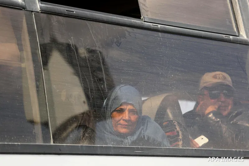 Palestinians look through a bus window waiting at the Rafah border crossing with Egypt before being allowed to pass out of the southern Gaza Strip on November 20, 2017, following its opening for three days for the first...