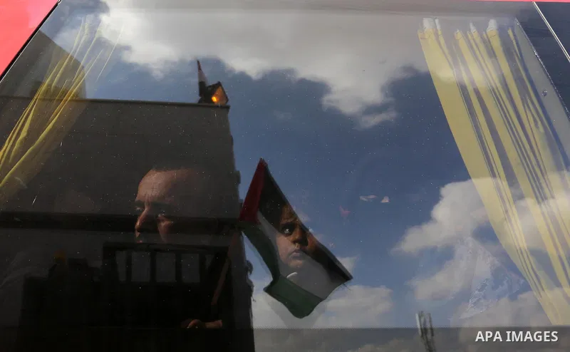 Palestinians look through a bus window waiting at the Rafah border crossing with Egypt before being allowed to pass out of the southern Gaza Strip on November 20, 2017, following its opening for three days for the first...