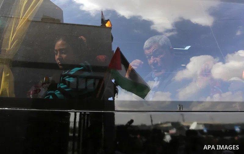 Palestinians look through a bus window waiting at the Rafah border crossing with Egypt before being allowed to pass out of the southern Gaza Strip on November 20, 2017, following its opening for three days for the first...