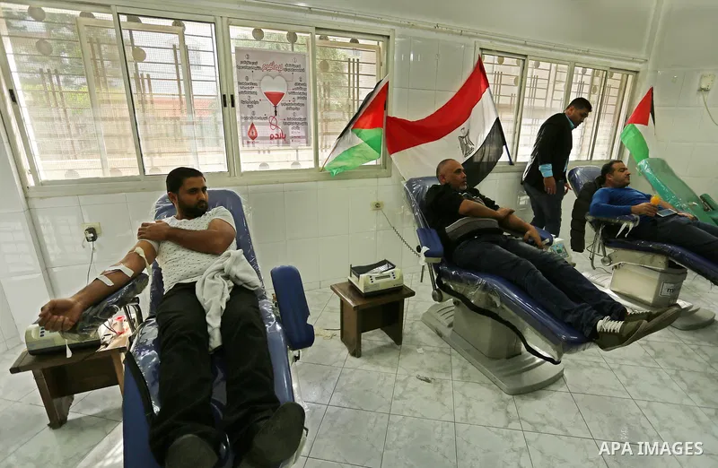Palestinian men donate blood for the Egyptian victims of the bomb and gun assault on the North Sinai Rawda mosque, in Gaza city on November 25, 2017. Armed attackers on November 24, 2017 killed at least 235 worshippers i...