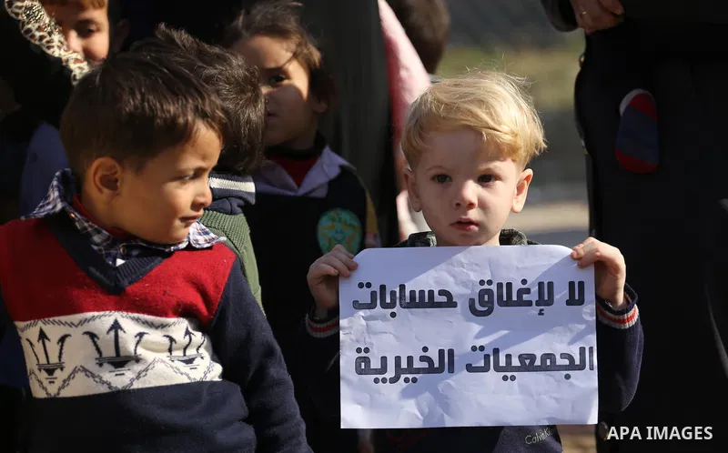 Palestinian orphans take part in a protest against the closure of the accounts of charities in Gaza city, on November 26, 2017. Photo by Mohammed Asad