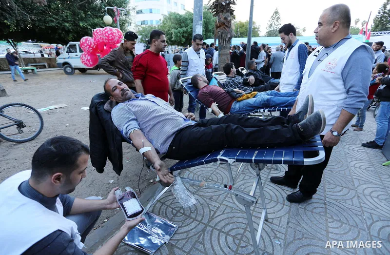 Palestinian men donate blood for the Egyptian victims in a mourning tent set up for people to pay their respects to the Egyptian victims after the deadly attack on a mosque in Egypt's Sinai, on November 26, 2017 in Gaza...