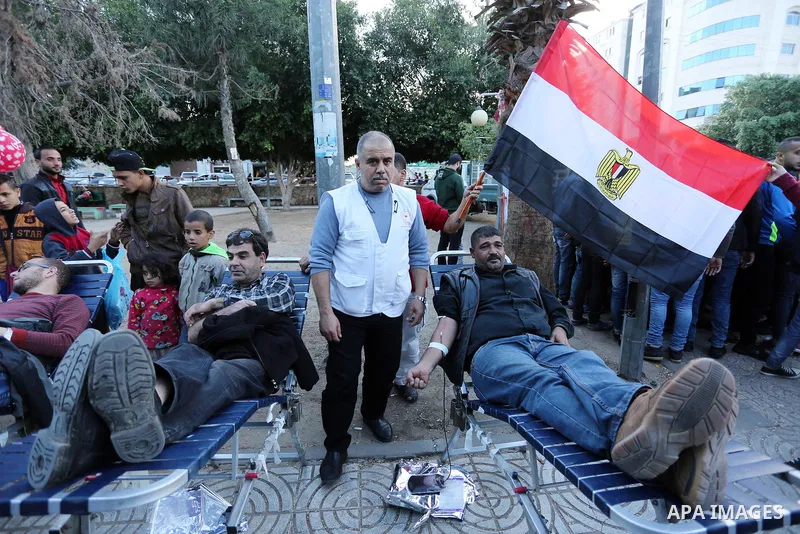Palestinian men donate blood for the Egyptian victims in a mourning tent set up for people to pay their respects to the Egyptian victims after the deadly attack on a mosque in Egypt's Sinai, on November 26, 2017 in Gaza...