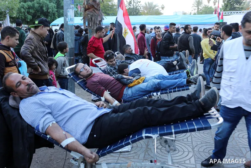Palestinian men donate blood for the Egyptian victims in a mourning tent set up for people to pay their respects to the Egyptian victims after the deadly attack on a mosque in Egypt's Sinai, on November 26, 2017 in Gaza...