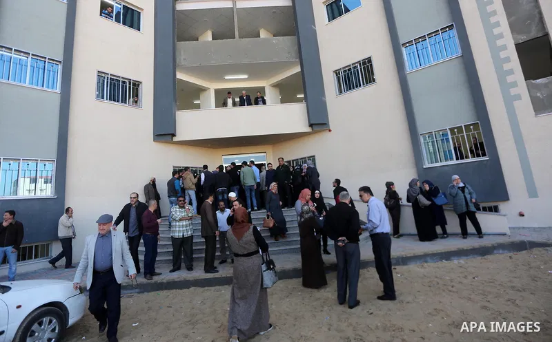 The Palestinian Authority employees, gather as they return to their offices in the headquarters of government ministries in the Gaza Strip in Gaza city on November 29, 2017. The Palestinian Authority began assuming power...