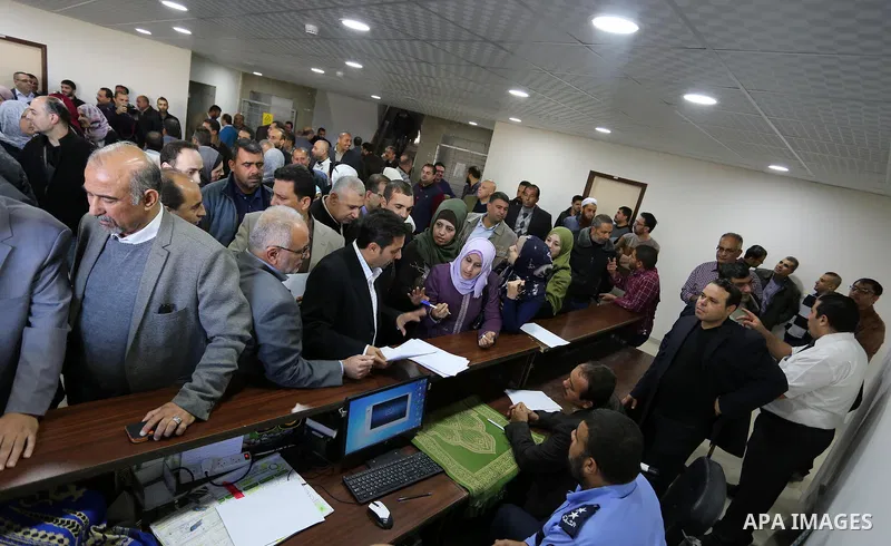 The Palestinian Authority employees, gather as they return to their offices in the headquarters of government ministries in the Gaza Strip in Gaza city on November 29, 2017. The Palestinian Authority began assuming power...