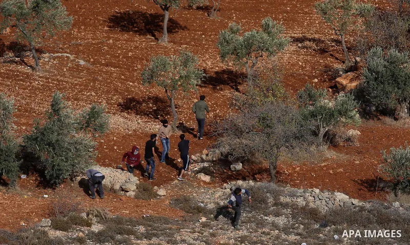 Palestinians throw stones at Israeli soldiers during clashes after confrontations with Israeli settlers in the village of Qusra, near the West Bank City of Nablus, 30 November 2017. According to reports, the Palestinian...