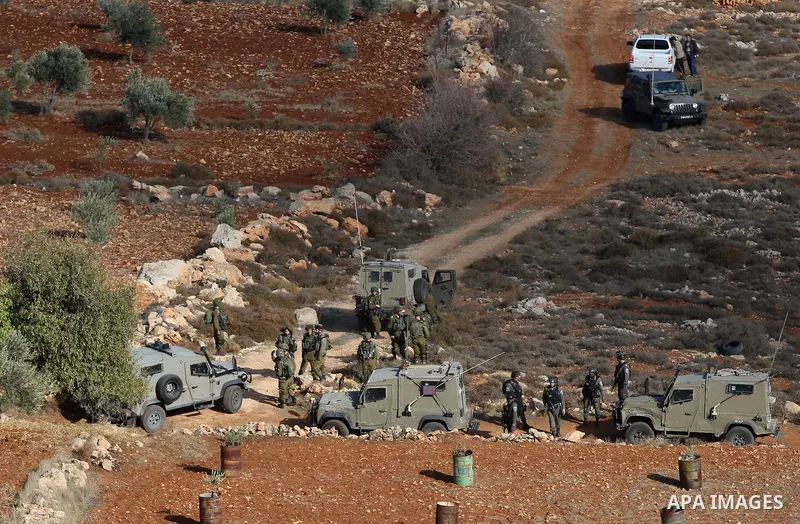 Palestinians throw stones at Israeli soldiers during clashes after confrontations with Israeli settlers in the village of Qusra, near the West Bank City of Nablus, 30 November 2017. According to reports, the Palestinian...