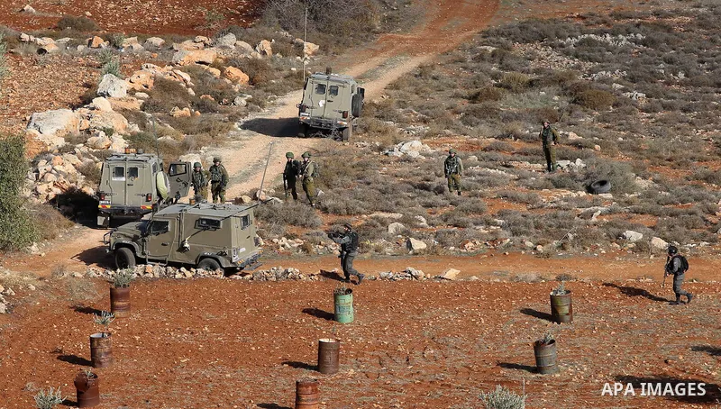 Palestinians throw stones at Israeli soldiers during clashes after confrontations with Israeli settlers in the village of Qusra, near the West Bank City of Nablus, 30 November 2017. According to reports, the Palestinian...