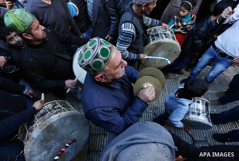 Worshipers sing and dance during a ceremony to commemorate the birth of the Prophet Mohamed in the West Bank city of Nablus, on Nov. 30, 2017. Photo by STR