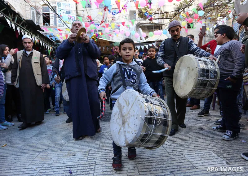 Worshipers sing and dance during a ceremony to commemorate the birth of the Prophet Mohamed in the West Bank city of Nablus, on Nov. 30, 2017. Photo by STR