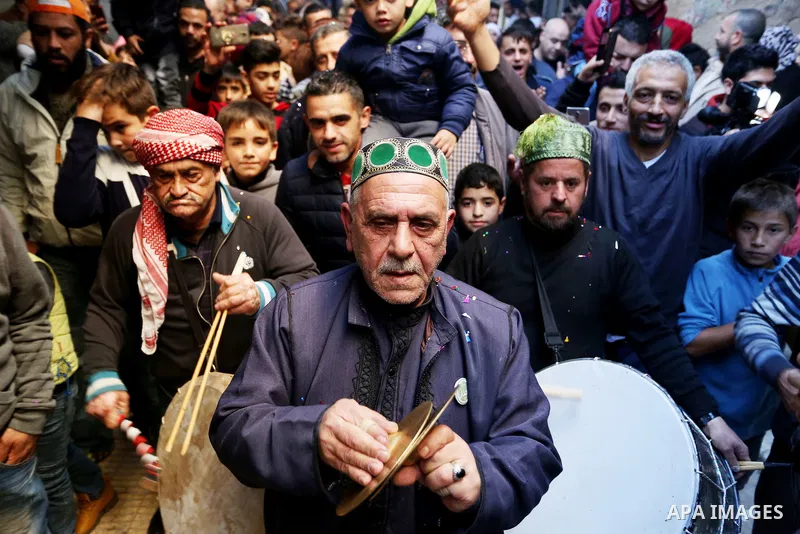Worshipers sing and dance during a ceremony to commemorate the birth of the Prophet Mohamed in the West Bank city of Nablus, on Nov. 30, 2017. Photo by STR