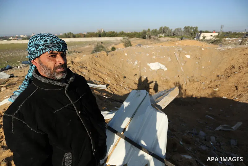 Palestinian men inspect the damage to a soccer field post after it was hit by an Israeli airstrike, on the outskirts of Gaza City December 1, 2017. Photo by Ashraf Amra