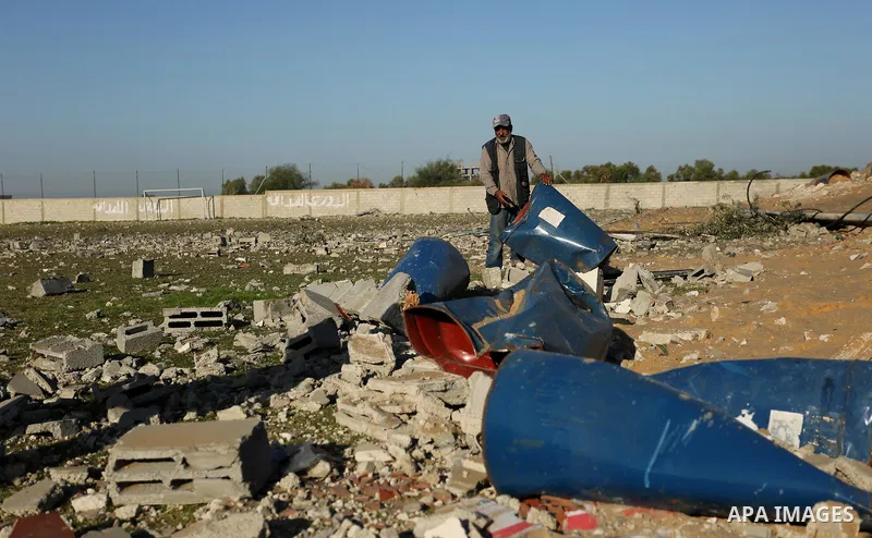 Palestinian men inspect the damage to a soccer field post after it was hit by an Israeli airstrike, on the outskirts of Gaza City December 1, 2017. Photo by Ashraf Amra