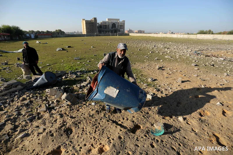 Palestinian men inspect the damage to a soccer field post after it was hit by an Israeli airstrike, on the outskirts of Gaza City December 1, 2017. Photo by Ashraf Amra