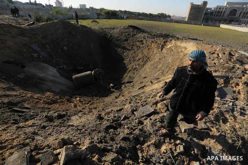 Palestinian men inspect the damage to a soccer field post after it was hit by an Israeli airstrike, on the outskirts of Gaza City December 1, 2017. Photo by Ashraf Amra