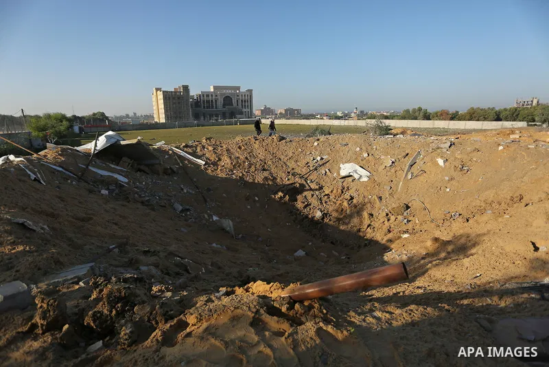 Palestinian men inspect the damage to a soccer field post after it was hit by an Israeli airstrike, on the outskirts of Gaza City December 1, 2017. Photo by Ashraf Amra
