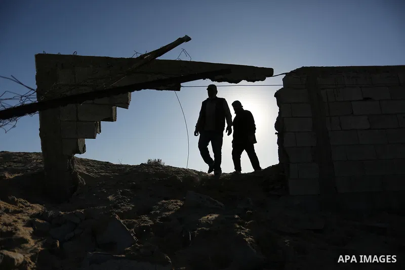 Palestinian men inspect the damage to a soccer field post after it was hit by an Israeli airstrike, on the outskirts of Gaza City December 1, 2017. Photo by Ashraf Amra