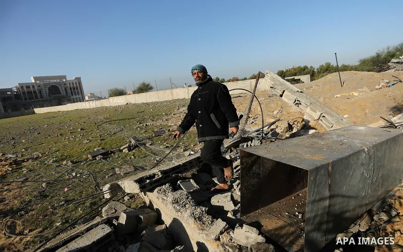 Palestinian men inspect the damage to a soccer field post after it was hit by an Israeli airstrike, on the outskirts of Gaza City December 1, 2017. Photo by Ashraf Amra