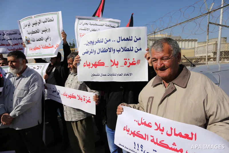 Palestinians take part during a protest against the ongoing electricity shortages in front of Gaza's power plant in Nuseirat, in the central of Gaza Strip on December 2, 2017. Photo by Ashraf Amra