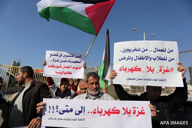 Palestinians take part during a protest against the ongoing electricity shortages in front of Gaza's power plant in Nuseirat, in the central of Gaza Strip on December 2, 2017. Photo by Ashraf Amra