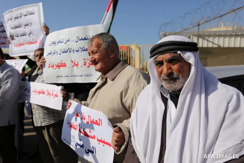 Palestinians take part during a protest against the ongoing electricity shortages in front of Gaza's power plant in Nuseirat, in the central of Gaza Strip on December 2, 2017. Photo by Ashraf Amra