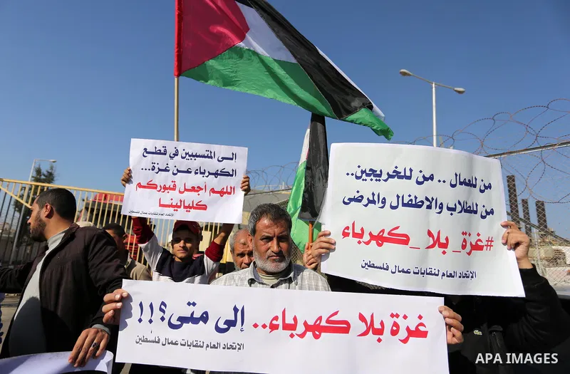 Palestinians take part during a protest against the ongoing electricity shortages in front of Gaza's power plant in Nuseirat, in the central of Gaza Strip on December 2, 2017. Photo by Ashraf Amra