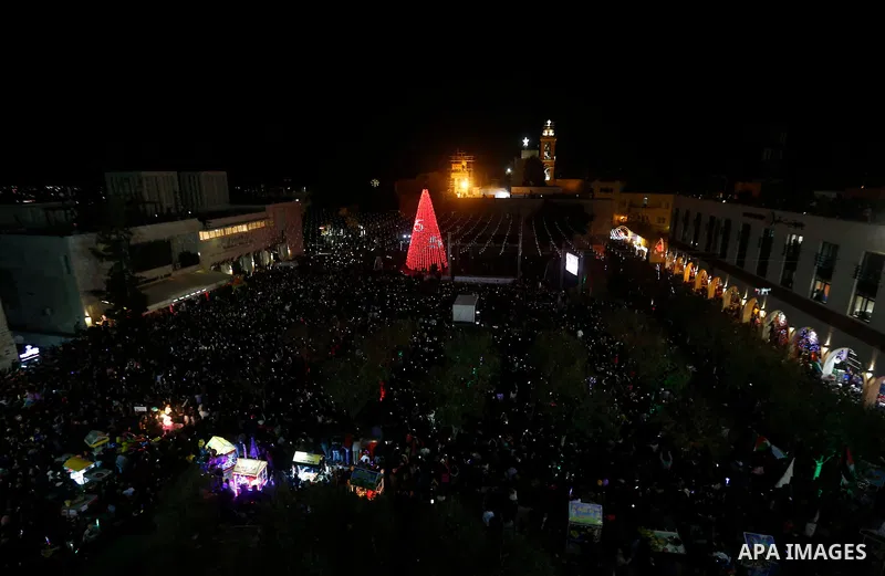 Fireworks explode during a Christmas tree lighting ceremony outside the Church of the Nativity in the West Bank town of Bethlehem, December 2, 2017. Photo by Wisam Hashlamoun
