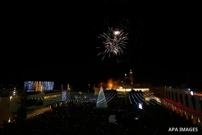 Fireworks explode during a Christmas tree lighting ceremony outside the Church of the Nativity in the West Bank town of Bethlehem, December 2, 2017. Photo by Wisam Hashlamoun