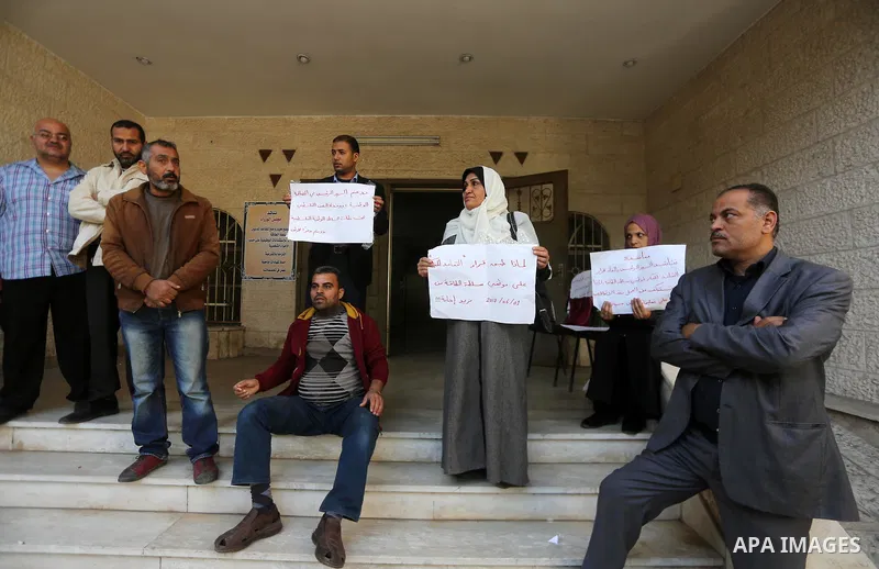 The Palestinian Authority employees in the Gaza Strip take part in a protest demanding their right after Palestinian Authority force them into early retirement in Gaza city on December 3, 2017. Photo by Mohammed Asad