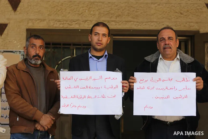 The Palestinian Authority employees in the Gaza Strip take part in a protest demanding their right after Palestinian Authority force them into early retirement in Gaza city on December 3, 2017. Photo by Mohammed Asad