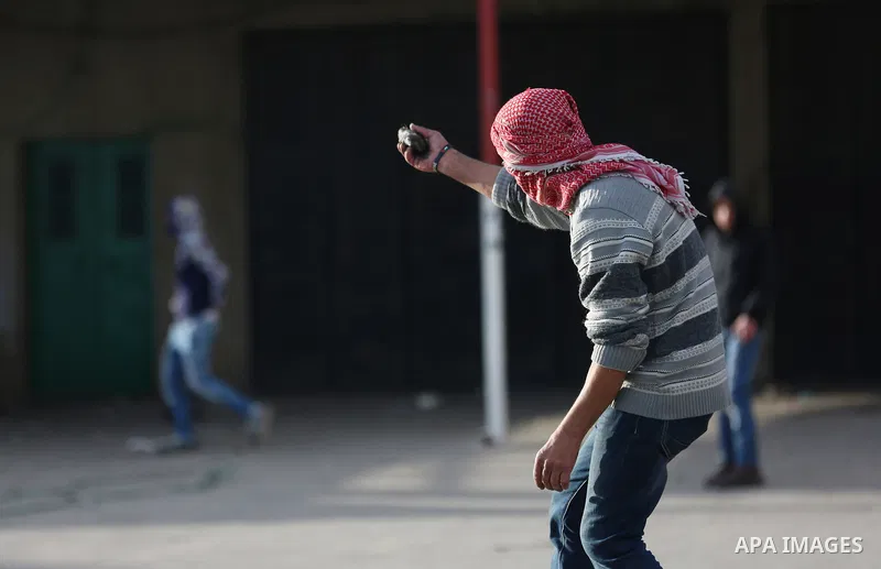 Palestinians throws stones at Israeli troops during clashes in Hawara checkpoint, south of the West Bank city of Nablus, following a demonstration against US President Donald Trump's decision to recognise Jerusalem as th...