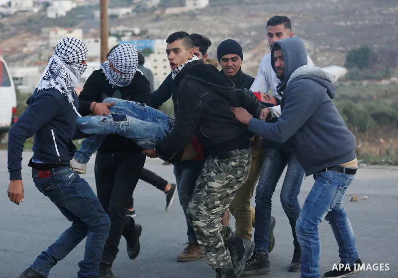 Palestinians throws stones at Israeli troops during clashes in Hawara checkpoint, south of the West Bank city of Nablus, following a demonstration against US President Donald Trump's decision to recognise Jerusalem as th...
