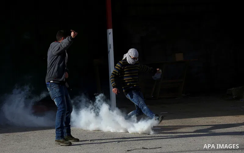 Palestinians throws stones at Israeli troops during clashes in Hawara checkpoint, south of the West Bank city of Nablus, following a demonstration against US President Donald Trump's decision to recognise Jerusalem as th...