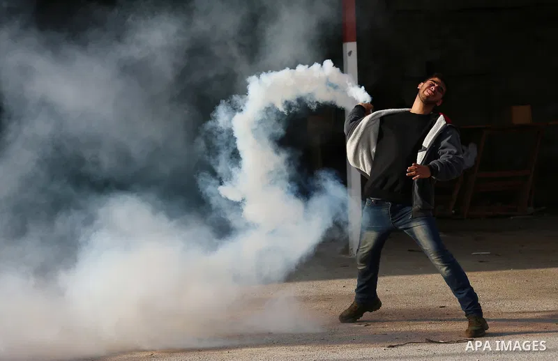 Palestinians throws stones at Israeli troops during clashes in Hawara checkpoint, south of the West Bank city of Nablus, following a demonstration against US President Donald Trump's decision to recognise Jerusalem as th...