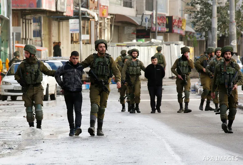 Israeli forces detain a Palestinian protester during clashes that followed protests against a decision by US President Donald Trump to recognise Jerusalem as the capital of Israel, in Hebron in the Israeli-occupied West...