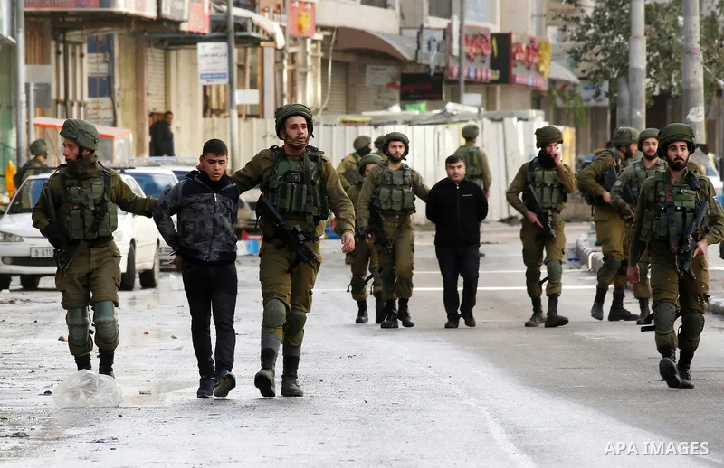 Israeli forces detain a Palestinian protester during clashes that followed protests against a decision by US President Donald Trump to recognise Jerusalem as the capital of Israel, in Hebron in the Israeli-occupied West...