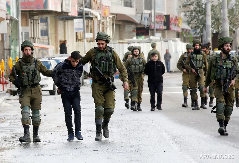 Israeli forces detain a Palestinian protester during clashes that followed protests against a decision by US President Donald Trump to recognise Jerusalem as the capital of Israel, in Hebron in the Israeli-occupied West...