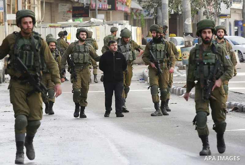 Israeli forces detain a Palestinian protester during clashes that followed protests against a decision by US President Donald Trump to recognise Jerusalem as the capital of Israel, in Hebron in the Israeli-occupied West...